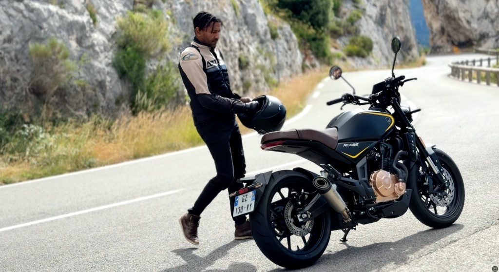 Riding for the video shoot of the Taro Scrambler — a motorcycle imagined, designed and clay-modeled by Yacouba Galle before production. A moment where the designer brings his own creation to life on the road.